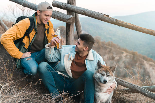 istock Two male friends drinking beer in nature 1594048902