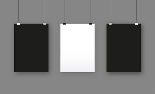 Black and white blank posters hanging with paper clips. A4 paper page, sheet on wall
