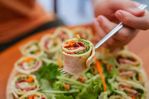 Slices of rolled sandwich wrapped in soft tortilla bread