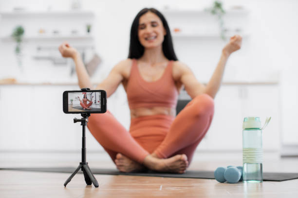 istock Female trainer shooting video about meditation indoors 1594114682