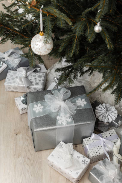 istock White and silver gift boxes under the Christmas tree 1594118296
