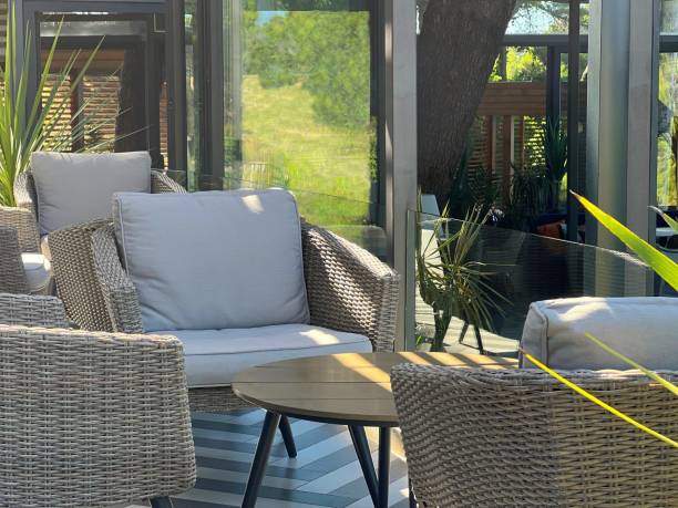 istock Cozy comfortable sofa, chairs, table for relaxation in a garden patio. 1594118521