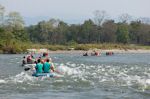 Nameri National Park, Assam, India - 8th April 2023: Ecotourists being paddled down the the Kameng River in Nameri NP, India.