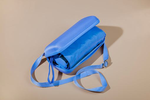 Close-up view of compact travel sun umbrella  with zipper storage case.