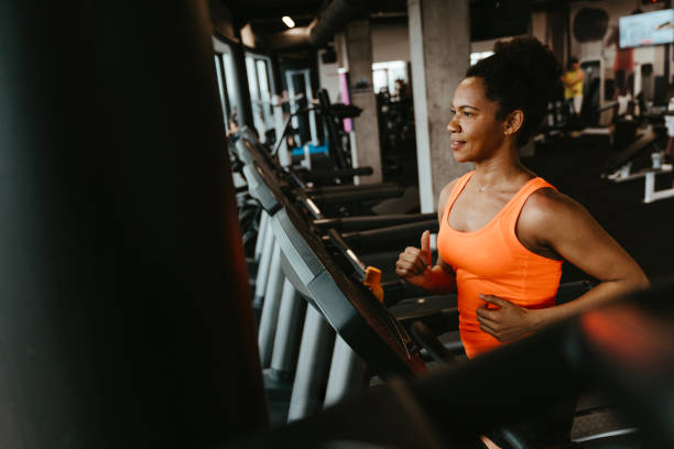 istock Dedicated focused young woman running on a treadmill 1594152232