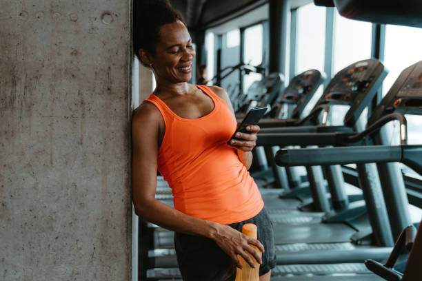 istock Woman texting on the phone after workout 1594152296