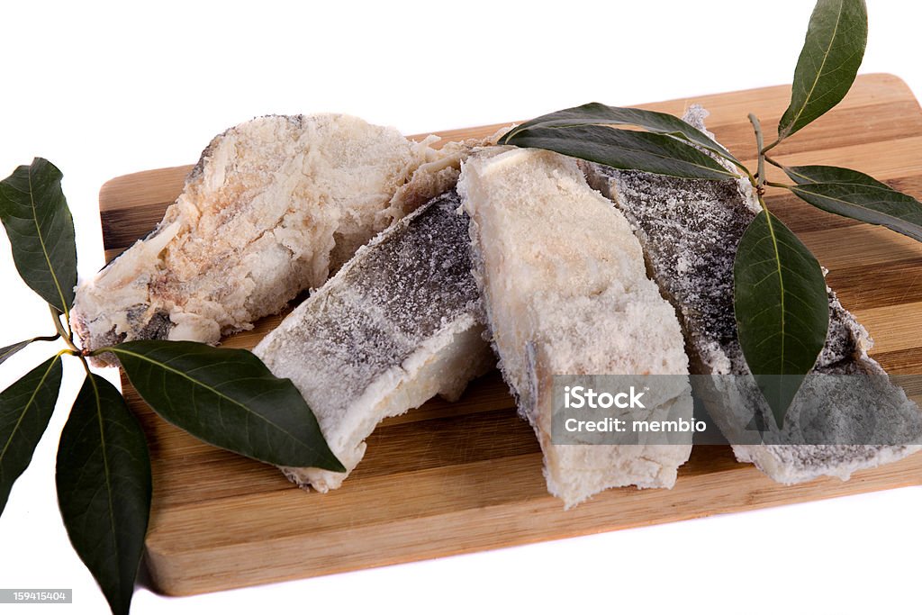 slices of salted cod View of a bunch of sliced salted codfish isolated on a white background. Cod Stock Photo