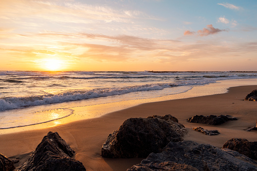 beautiful sunset over the rocky coast in summer