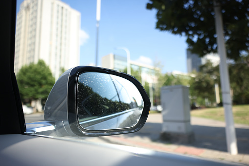 A car driving in the city, close-up of the reversing mirror