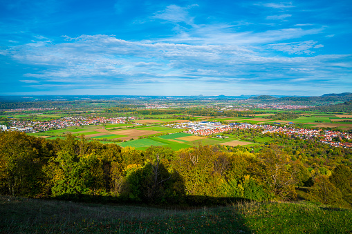 Germany, Wide view, swabian alb nature landscape, bissingen unter teck city houses, sunny day autumn colorful, blue sky sun, breitenstein mountain