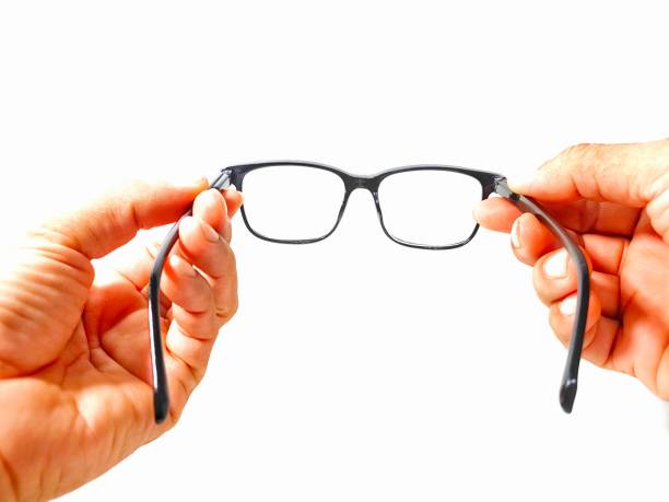 istock male hand holding glasses on a white background 1594158524