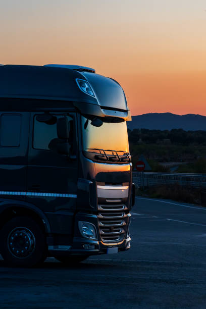 istock Truck stopped in a parking lot taking a break at sunset. 1594159727