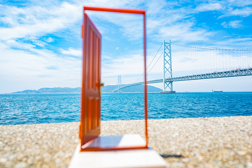 This photograph represents the image of crossing to the other shore, symbolizing the opening of the door to a new world. Please use it in scenes that express challenges and growth.

The Akashi Kaikyo Bridge is the world's longest suspension bridge that connects Kobe City and Awaji Island in Japan. With a total length of approximately 3.9 kilometers, its breathtaking beauty and majestic presence captivate many people. Crossing this bridge gives you the sensation of traveling over the sea. While being caressed by the sea breeze, you can enjoy the magnificent views all around. The Akashi Kaikyo Bridge represents the pinnacle of Japanese engineering and stands as an impressive structure that I warmly invite tourists from abroad to experience.