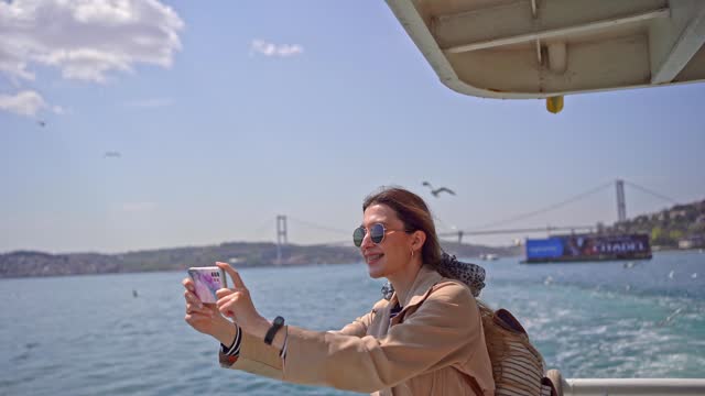 Woman filming the view from the ferry boat