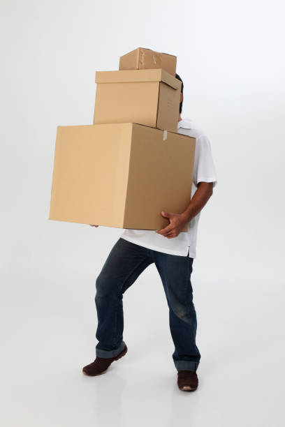 istock man struggling to carry moving boxes. 1594178824