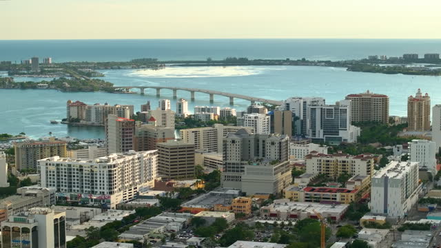 Above view of Sarasota city, Florida with waterfront office highrise buildings and John Ringling Causeway leading from downtown to St. Armands Key. Development of housing and transportation in the US