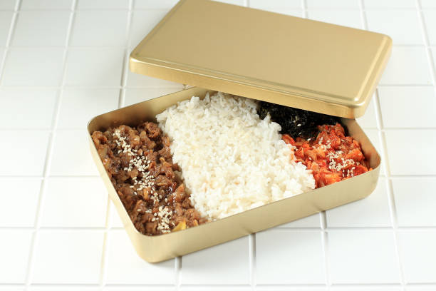 Korean Style Packed Meal with Bulgogi, Kimchi, and Nori Flakes stock photo