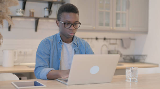 istock Young African Man Working on Laptop 1594198472