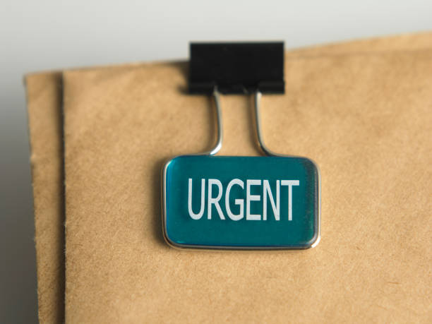 istock close up of urgent clip on the brown  document 1594200953