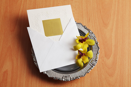 invitation card on the tray with flower