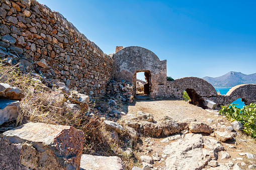Ruins of apartments on the island of Spinalonga. Spinalonga fortress on the island of Crete, Greece. Here were isolated lepers, humans with Hansen's disease.