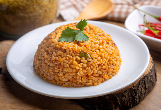 istock Traditional turkish bulgur pilaf with tomato sause in plate (Turkish name; meyhane pilavi) 1594242860