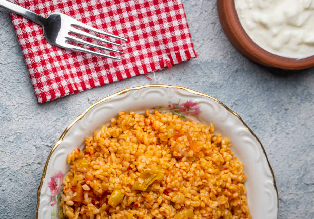 istock Traditional turkish bulgur pilaf with tomato sause in plate (Turkish name; meyhane pilavi) 1594264630