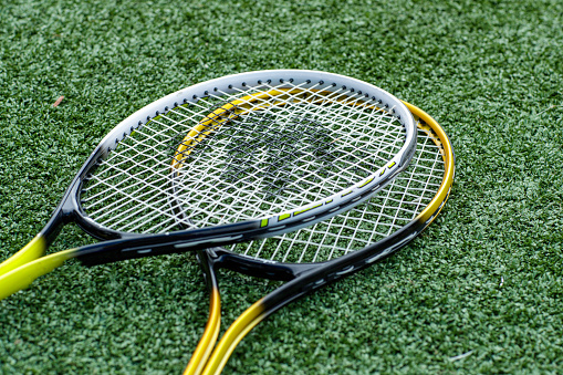 Two tennis rackets on a tennis court