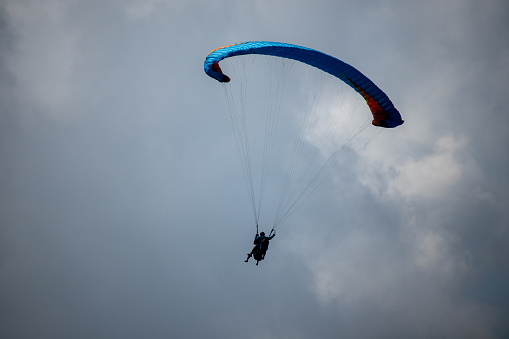 Bogor - Indonesia February 21, 2022 tourists play paragliding in the Puncak Bogor area, paragliding tours