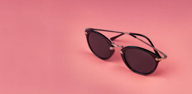 istock Sunglasses on pink background with copy space 1594276296
