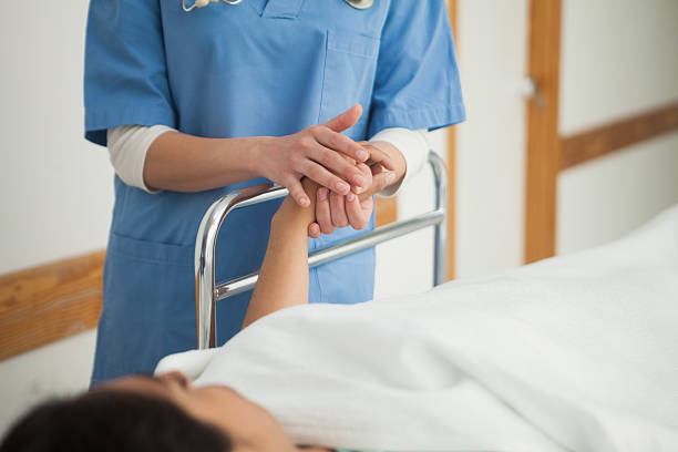 istock Patient lying on a medical bed holding the hand 159427834