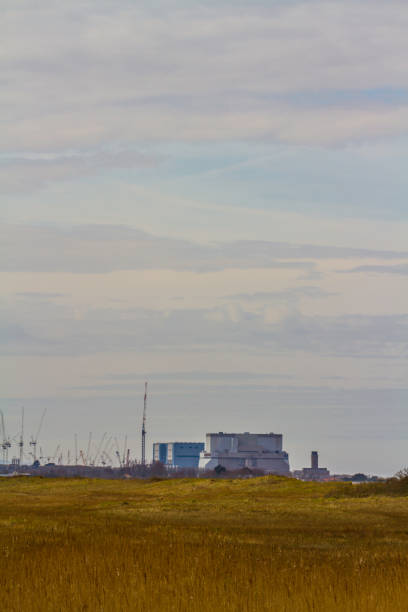 istock Nuclear Power Station in distance, copyspace on top, portrait. 1594292108