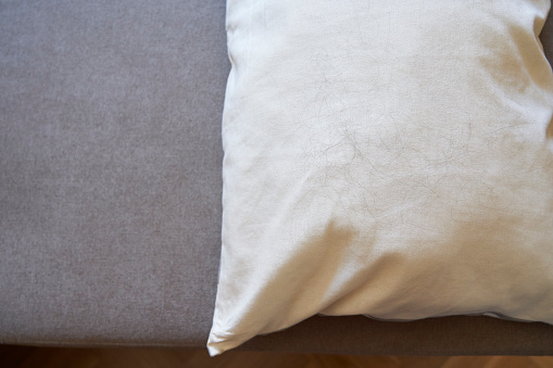 Close-up of bundle of hair on a pillow due to hair loss problem