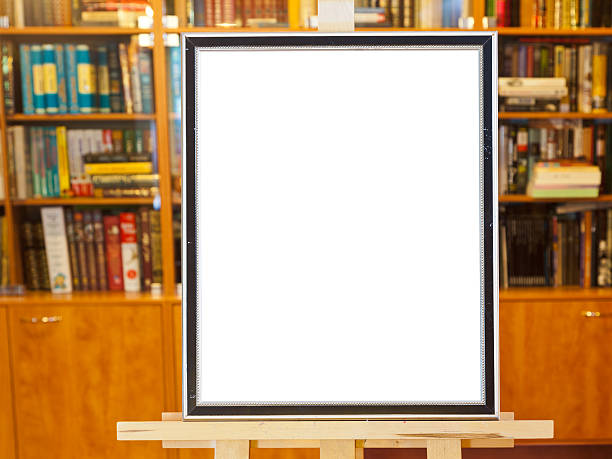 istock white canvas of picture frame on easel in library 159429513