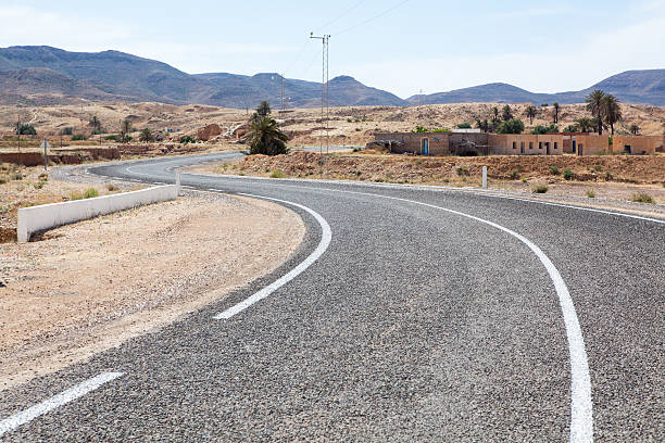 istock Asphalt way with white road marking in mountain terrain 159429545