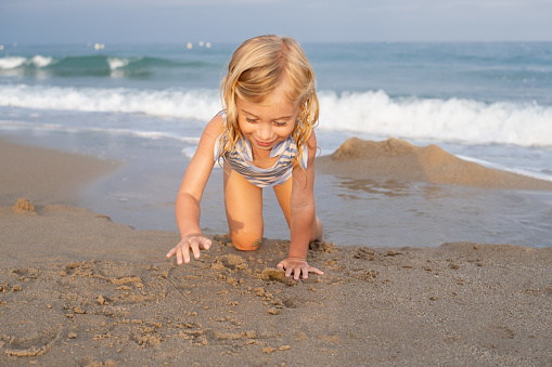girl playing in sand-littlegirl playing in sand-little
