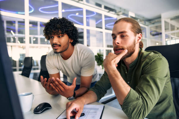 istock Male freelancers argue about working in a coworking space office 1594319323