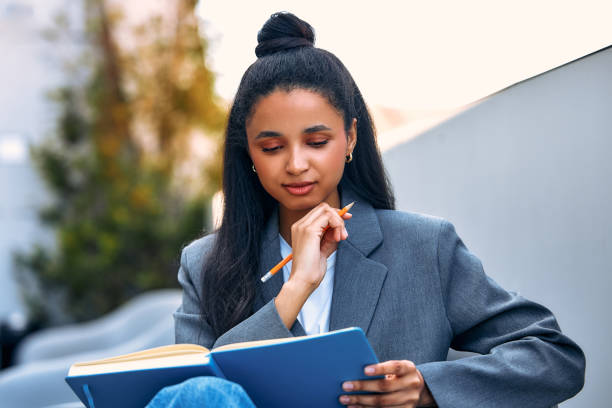 istock Woman with a notebook on the street 1594339200