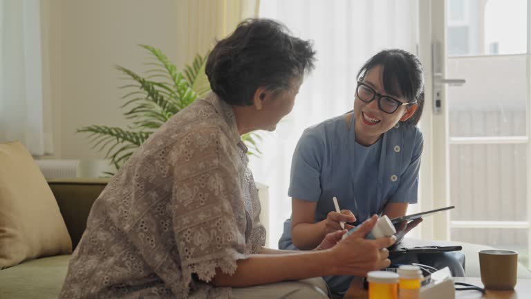 Nurse Providing Medical Advice to Elderly Patient.