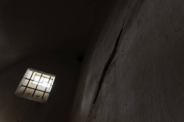 istock Barred window in a an old solitary confinement cell 1594348919