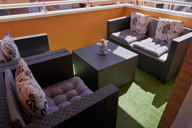 istock Terrace with rattan table and chairs with cushions and grass 1594361684