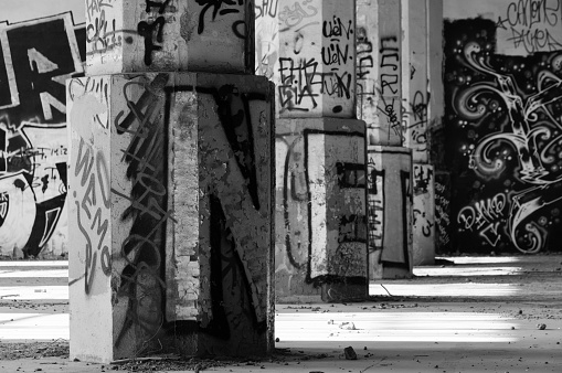 Very old and abandoned school with brick walls marked by letters, dates, and signs made by school children.\nOld red brick wall grunge texture. Old cracked bricks wall with a weathered surface. Brick wall background, copy space for design and text. Vintage brick wall.