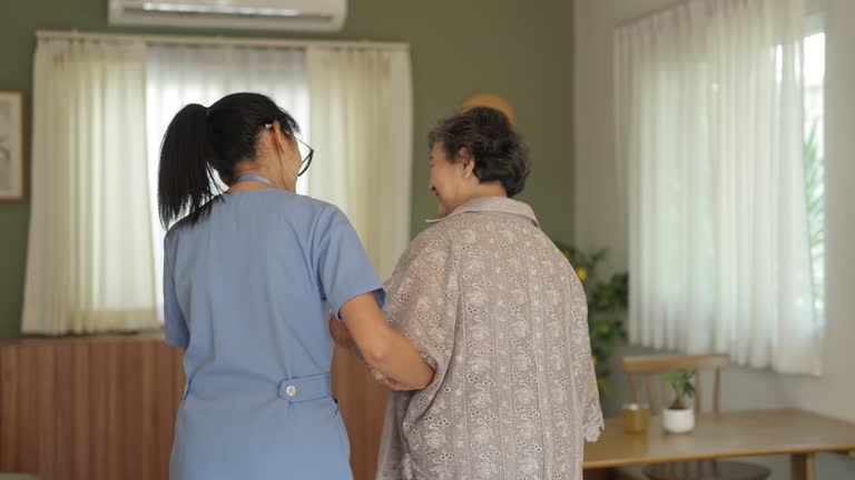 healthcare worker helping senior patient walking at home