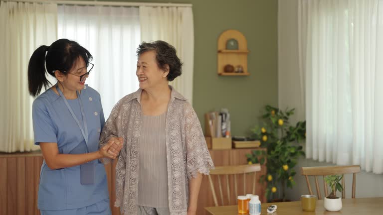 healthcare worker helping senior patient walking at home