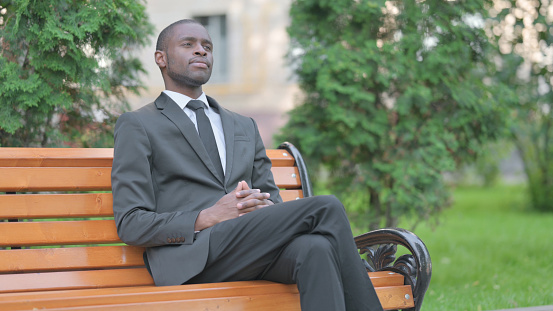 Serious African Businessman Sitting Outdoor