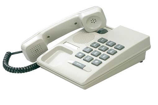 Black digital desktop IP telephone, close-up on white background