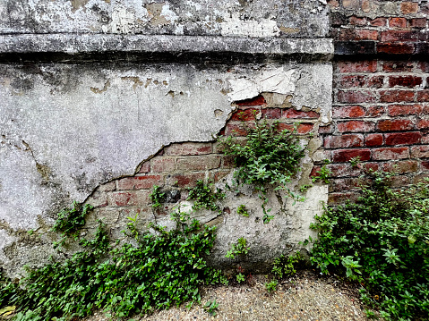 Section of an old brick wall that has been damaged over time.