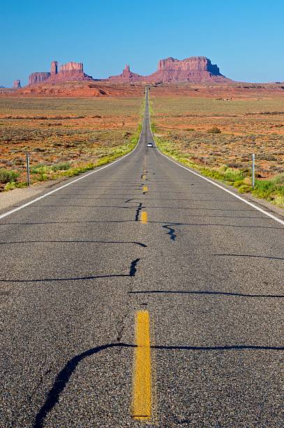 Country Highway - Utah, USA Straight country highway 163 with gorgeous monument valley in background - Utah, USA single yellow line sunlight usa utah stock pictures, royalty-free photos & images