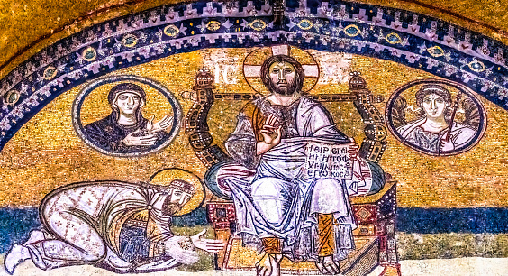 Byzantine mosaic of Jesus Christ is sitting on throne with Empress Zoe and Emperor Constantine IX Monomachus in Hagia Sophia