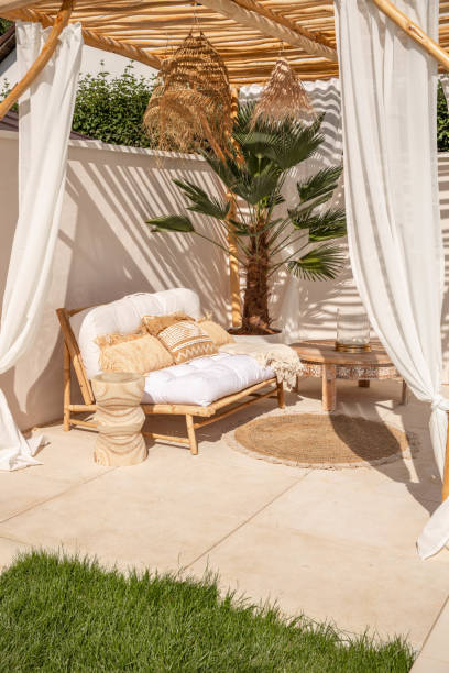 istock Boho bamboo outdoor sofa under driftwood pergola in warm sunlight 1594480035